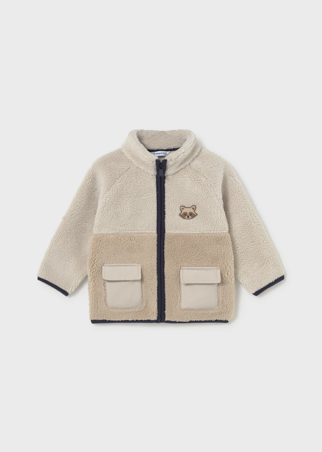 Mayoral baby boys’ beige and taupe teddy fleece jacket with a textured finish, navy front zip, contrast edging, two flap pockets and an embroidered animal face motif.