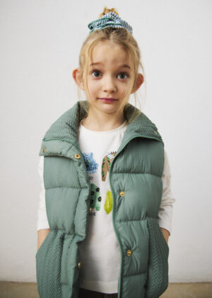 Girl wearing the Mayoral padded waistcoat in Green